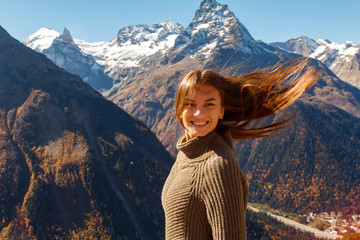 Nice Girl traveler in the background of the mountains