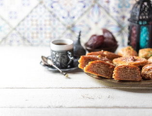 Ramadan kareem with arabic coffee and traditional arabic dessert baklava with honey and nuts. Arabian style. Ramadan breakfast concept.