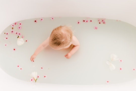 Baby in a flower bath with cherry blossoms
