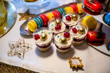 colorful macaroons cookies and cakes on the table