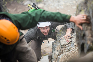 Two climbers ascend a rocky gully on Sky Pilot Mountain, B.C., Canada
