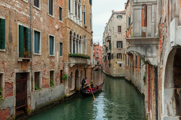 Fototapeta na wymiar A beautiful photo of the canals of Venice through which gondolas walk and carry tourists