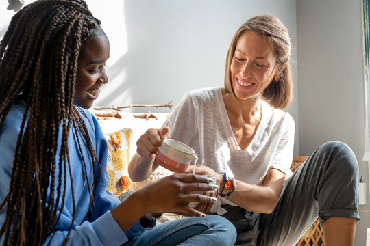 Two friends drinking tea at home