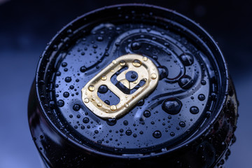 black aluminum can with spray of water spins