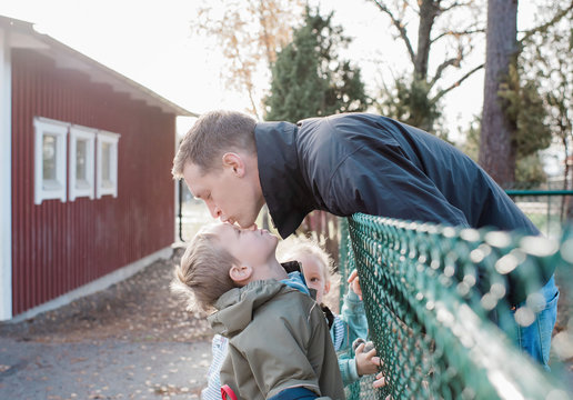 Father Kissing His Son Goodbye At The School Gate