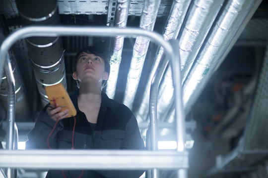 engineer woman with a device checking and controlling