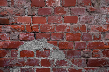 Red brick wall texture background. Old weathered and cracked red and orange bricks with concrete. Close up, copy space