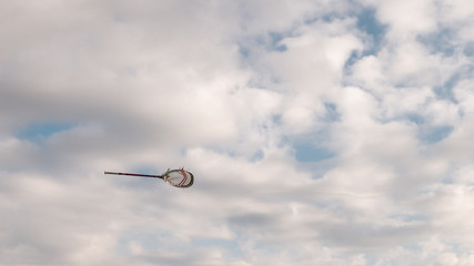 flying lacrosse stick against the sky