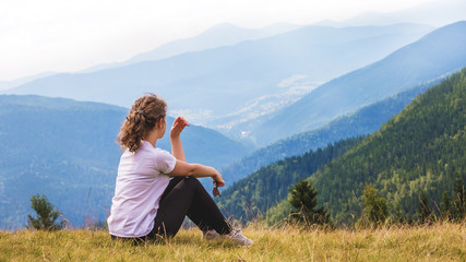 Young girl in the mountains enjoying the beauty of nature_