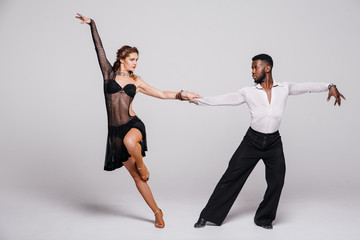 Couple dancers posing over white background. Dance school concept