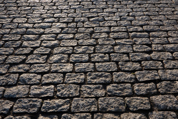 A perspective view of a gray cameo pavement. The stones have the same rectangular shape and size....