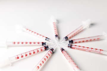 Pile of medical syringes for insulin for diabetes. Syringe on white background 