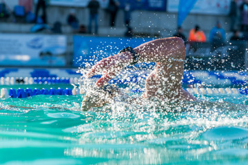 Athlete swimming in clear blue water