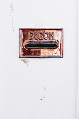 Mailbox detail in Seville, Spain inside a portal in the historic center. It writen 'buzon' which means the place to put the correspondence