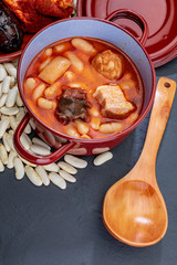 Appetizing spoon dish. Asturian fabada, typical dish of Asturias (Spain). Stew of beans (white beans) with chorizo, bacon, black pudding, bacon, onion, garlic, parsley and salt.