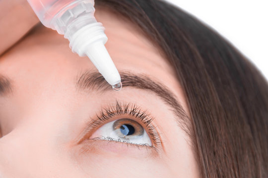 Closeup Female Hand Is Holding Little Bottle With Healing Drops. Young Woman Is Going To Drip Medication, Artificial Tear Into Eye. Treatment And Prevention Ophthalmic Diseases Concept.