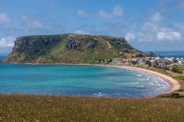 Stanley, Tasmania, Australia - December 15, 2009: The Nut volcanic plug and part of town under blue cloudscape.
