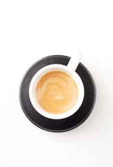 Cup of coffee on white paper background. Top view. Copy space.