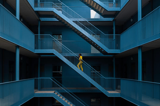 Woman walking on staircase of building