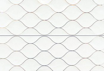 White ceramic tiles in the form of scales. Tile texture with a marine design.