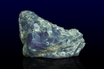 Rock of blue calcite mineral on dark background