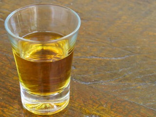 glass of cachaça on wooden table