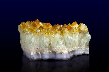 Citrine mineral close up. Stone crystals isolated on dark background. Gemstone, pattern