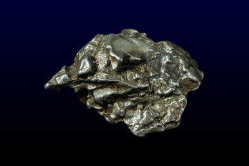 Fragments Detail view of isolated meteorite on dark background 