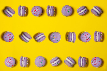 a lot of purple macarooos on yellow background