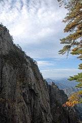 Huangshan Mountain in Anhui Province, China. Viewpoint near Flying-Over Rock or Feilai Stone. Scenic view of cliffs, pine tree and a valley on Huangshan Mountain, China.