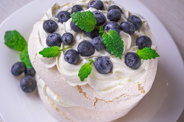 Pavlova cake topped with blueberries. Delicious dessert.