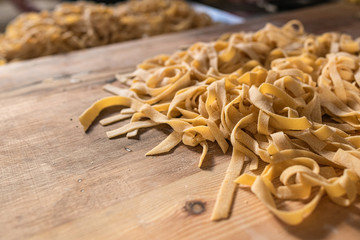 Preparing Fresh Fettuccine Pasta on a wooden table in an Italian Home on a sunday morning