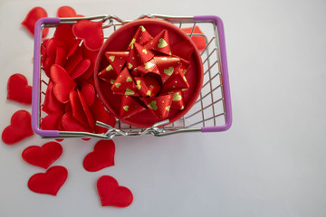 Gift shopping, shopping cart is full of gift boxes and red hearts. Valentine's Day shopping concept. top view. Shopping romantic
