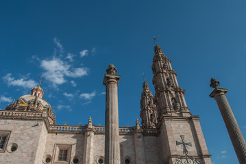 The Cathedral/Basilica of the Virgin of San Juan de los Lagos has a facade of pink sandstone with two narrow Baroque towers and a portal with three levels and a crest