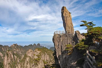 Peel and stick wall murals Huangshan Huangshan Mountain in Anhui Province, China. Landscape view of Flying-Over Rock or Feilai Stone with the peaks of distant mountains. This is one of the most famous sights on Huangshan Mountain, China