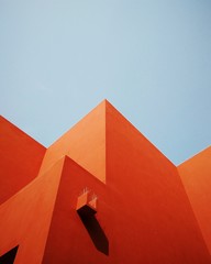 Low Angle View Of Orange Building Against Clear Blue Sky
