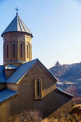 Georgia, Tbilisi-Narikala Church. Narikala fortress is an ancient citadel in the historical part of Tbilisi. In the background on the hill Tabor Monastery of the Transfiguration
