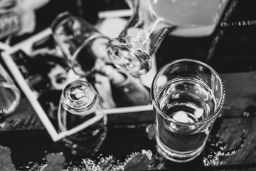 alcoholism and divorce. Fallen drink glasses on wooden table, torn family photo. Concept of divorce and addiction problems with drinking.