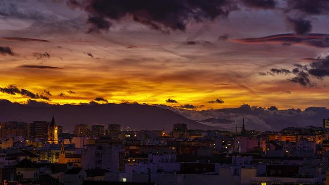 Malaga City time lapse of colorful sunset in Andalusia, Spain