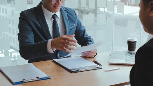 Senior manager reading a resume during a job interview employee young man meeting Applicant and recruitment concept