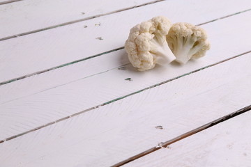 Pieces of raw cauliflower in color background