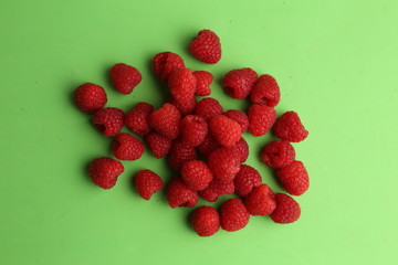 delicious raspberries in colorful background