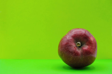 Red apple on neon green background in Ukraine. Health concept. Copy space.  Minimalism.