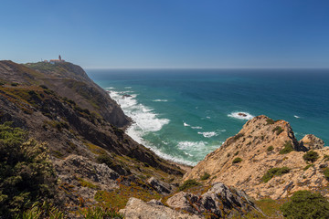 Scenic view of the rugged and dramatic coast at Cabo da Roca, the westernmost point of continental Europe, lighthouse and the Atlantic Ocean in Portugal.