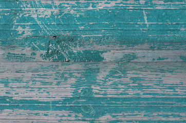 Old board with peeling paint. Green wooden rustic background. Fence.