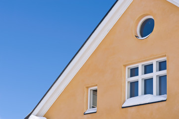 Fototapeta na wymiar Detail of house exterior against blue sky.