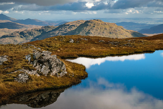 Beinn a'Chroin's dramatic rocky features reflecting in a small pond. Beinn a'Chroin is a small munro in Scottish Highlands to the south of Crianlarich.