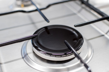 Close up shot of rapid burner on stainless steel gas hob with thin bar pan supports