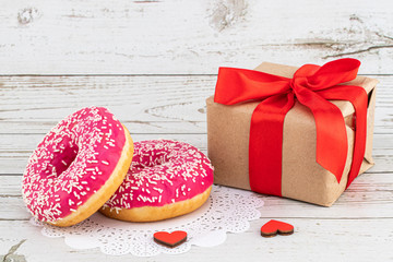 Fototapeta na wymiar Valentine's day romantic breakfast. Gift, hearts and donuts. Valentines day concept. Copy space