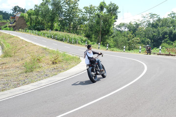Fototapeta na wymiar Man riding a motorcycle on the highway
